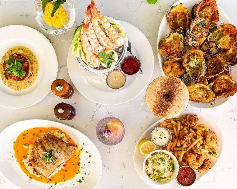 A seafood spread of shrimp cocktail, baked oysters, fish and chips, and pan-seared fish from C&S Oyster Bar in Brookhaven GA