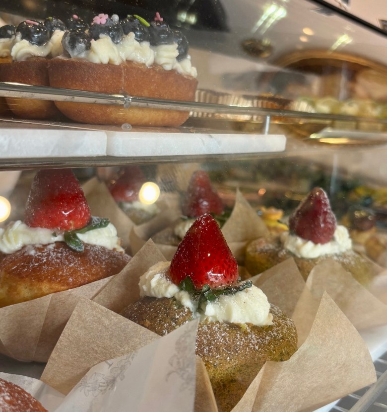 A row of green tea castella, a Japanese sponge cake flavored with honey filled the middle with vanilla buttercream and crowned the top with a strawberry from Bread Museum in Duluth, GA
