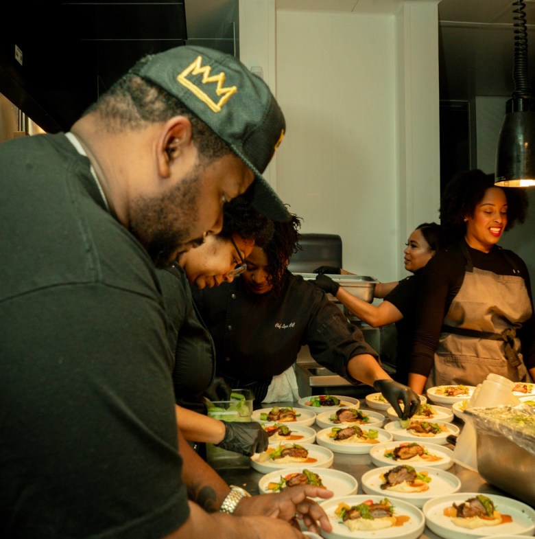The New South chefs, a collective of Black Atlanta chefs, working together in the kitchen to plate dishes for one of the group's dinners.