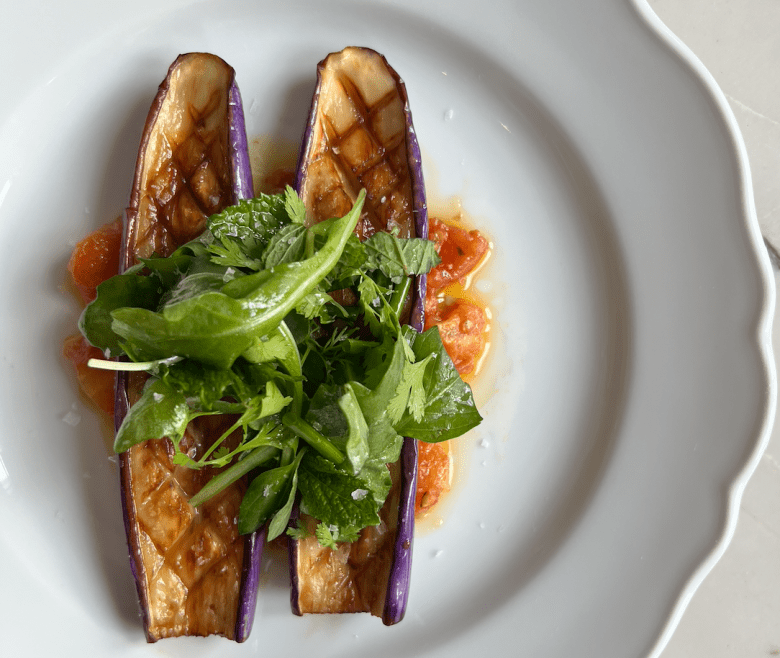 Seared eggplant with marinated roasted tomatoes from Lucian Books and Wine in Buckhead. (Photo courtesy Lucian Wine and Books).