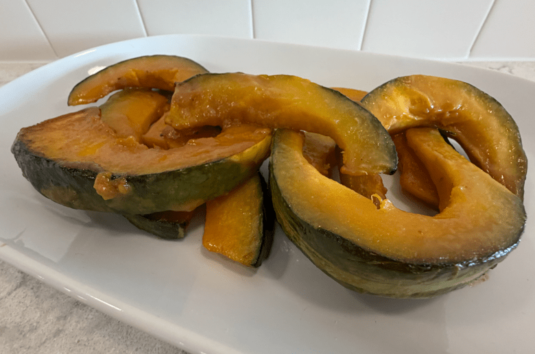 Overhead shot of miso-glazed kabocha squash on a white serving dish. 